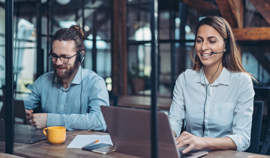 Two people from support smiling.